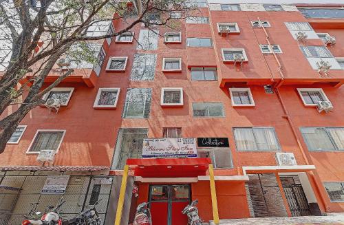 a red building with a red door in front of it at The Blooms stay inn in Bengaluru