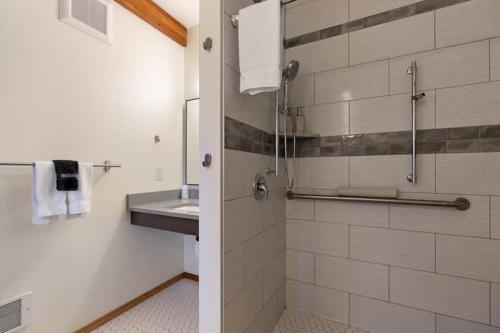a bathroom with a sink and a shower at Snowcreek Suite - Cedar - ADA- Hot Tub - Kitchenette in Leavenworth