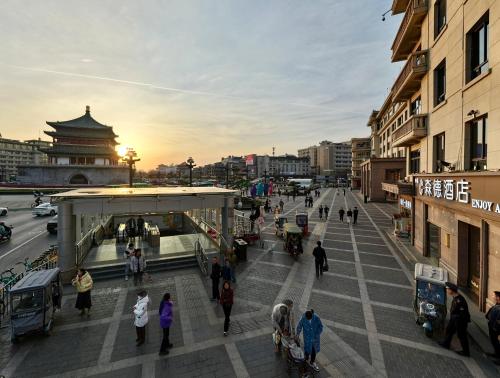 a group of people walking on a city street at Center Hotel Xi'an Bell Tower in Xi'an