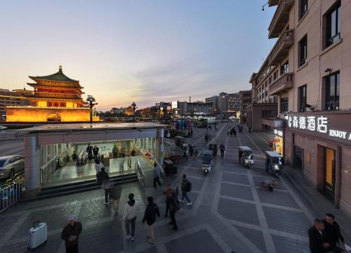 a group of people walking on a city street at Center Hotel Xi'an Bell Tower in Xi'an