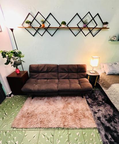 a living room with a brown couch and a rug at Departamento Estudio en el Centro de Monterrey in Monterrey