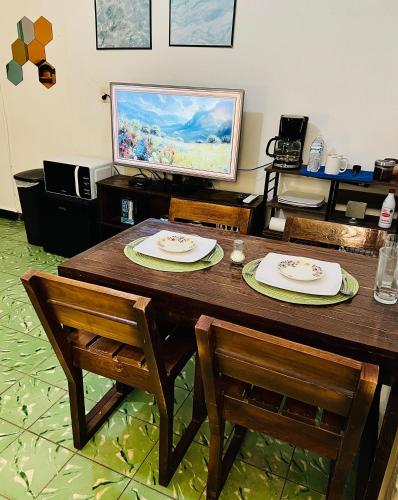 a wooden table with two plates on top of it at Departamento Estudio en el Centro de Monterrey in Monterrey