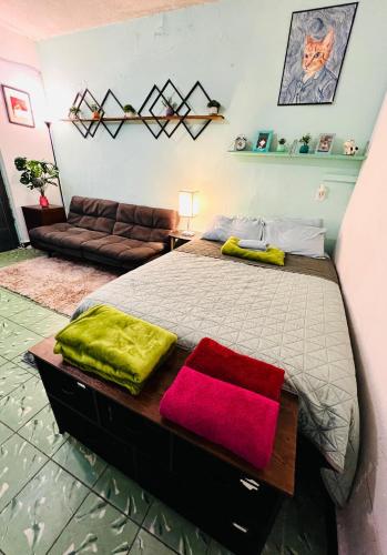 a bedroom with a bed with two pillows on it at Departamento Estudio en el Centro de Monterrey in Monterrey