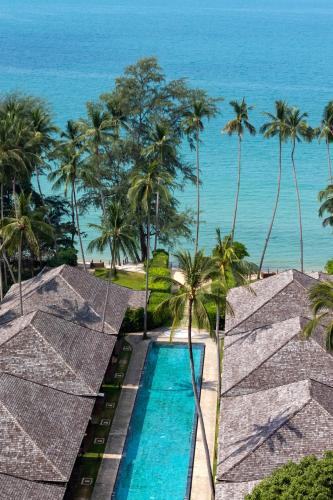 a view of the ocean from a resort with a swimming pool at Nikki Beach Resort & Spa Koh Samui in Lipa Noi