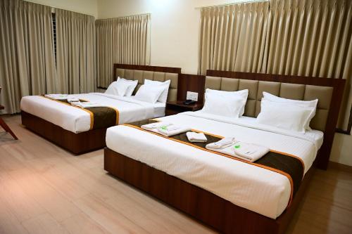 Ένα ή περισσότερα κρεβάτια σε δωμάτιο στο Unnati Stay Inn Vijayapura