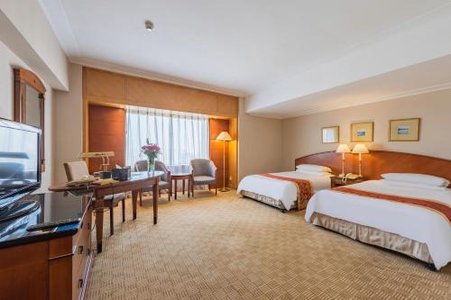Ένα ή περισσότερα κρεβάτια σε δωμάτιο στο Ruishi Hotel Dalian