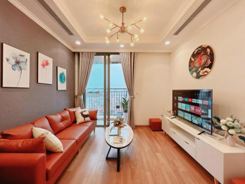 a living room with a couch and a television at Luxury Apartment in Vinhomes Times City - KaBi Home in Hanoi