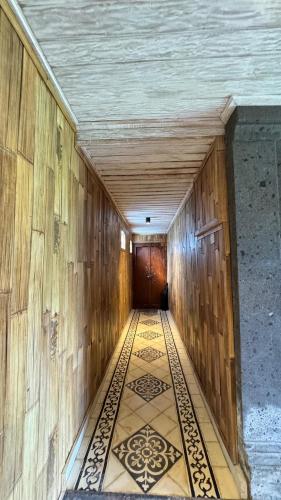 an empty hallway with a door and a tile floor at Villa Karma Loka in Sidemen