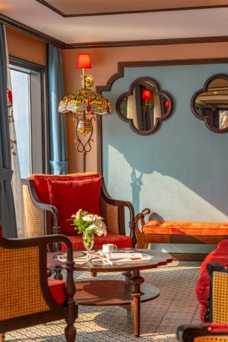 a living room with a chair and a table at Indochine Grand Lan Ha Bay in Ha Long