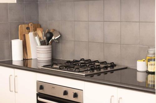 a kitchen counter with a stove top oven at Drummond Living Spacious 3BR Home in Town in Ballarat