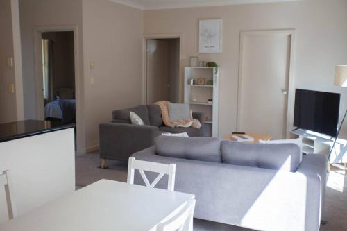 a living room with a couch and a tv at Drummond Living Spacious 3BR Home in Town in Ballarat