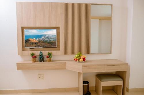 a dressing table in a room with a mirror at Lanxy Hotel Nha Trang in Nha Trang