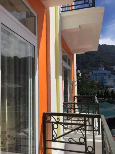 a balcony of a house with an open window at Hòa Bình Tam Đảo Hotel in Tam Ðảo