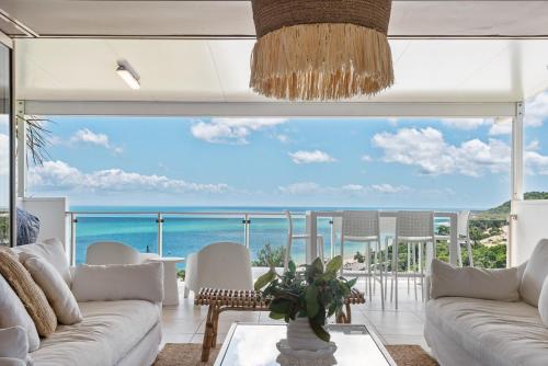 a living room with a view of the ocean at Breathe On Moreton will take your breath away in Tangalooma