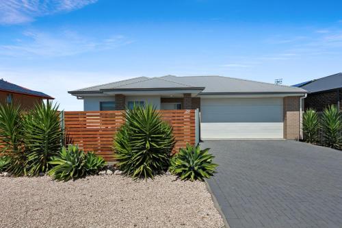 a house with a brick fence and a garage at 29 Blanche Pd, Hindmarsh Island in Hindmarsh Island