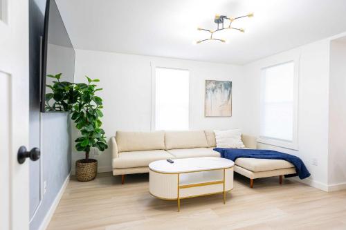 a living room with a couch and a table at Modern East Boston 2 Bed 2 Bath in Boston