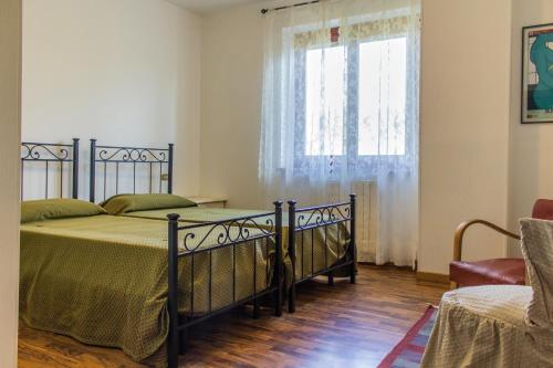 a bedroom with a bed and a window at Le Monachette in Ascoli Piceno