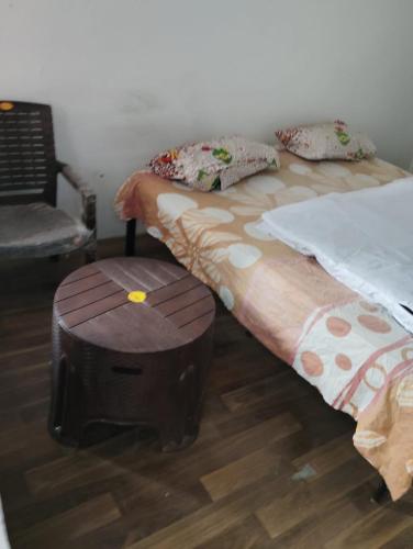 a bedroom with two twin beds with a ottoman at Mount view guest house in Jammu