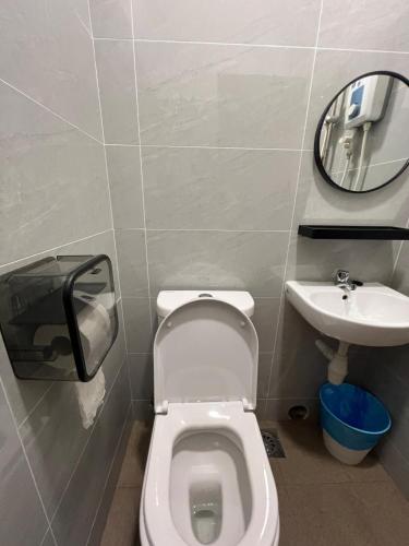 a bathroom with a toilet and a sink at Hidden Gem For Family 7Pax with Free WIFI in Cheras