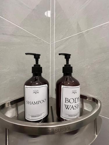 two bottles of soap on a metal shelf in a bathroom at Hidden Gem For Family 7Pax with Free WIFI in Cheras