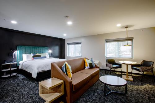 a hotel room with a bed and a couch at voco Flagstaff by IHG in Flagstaff