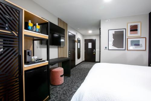 a hotel room with a bed and a desk at voco Flagstaff by IHG in Flagstaff