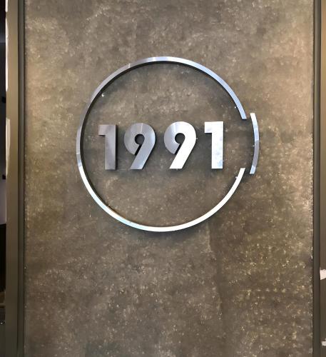 a sign on a wall with the number at 1991 Boutique Hotel in Phan Thiet