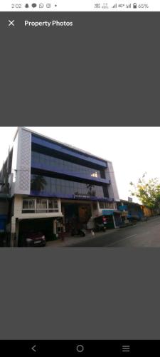 a large building with a street in front of it at Hotel Blue Bird Nest in Bumlitan