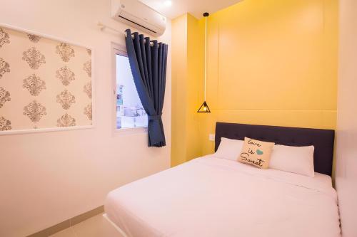 a bedroom with a bed and a window at 1991 Hotel in Phan Thiet