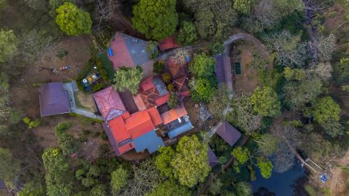 an overhead view of a house in the forest at Hill Valley Farm House in Nelliyampathy