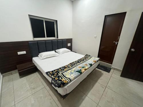 a large bed in a room with at Hotel Mewad Palace in Chharodi
