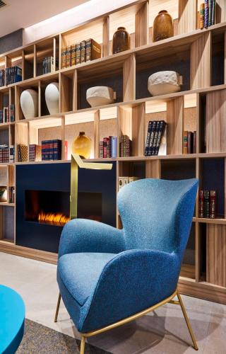 a blue chair in a room with a fireplace at Sercotel Ayala in Bilbao