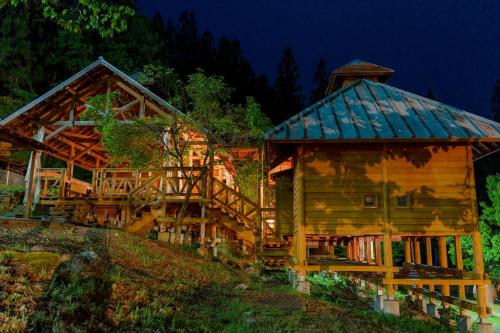 a log cabin with a staircase leading to a house at Hida-Osaka Fureai no Mori Bungalow in Gero