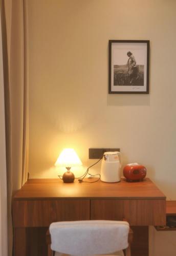 a table with a lamp on top of it at Kashgar QIu Ge Homestay in Kashgar