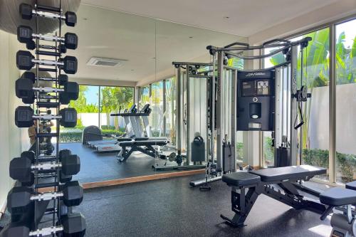 a gym with several tread machines and a mirror at Modern 3BR Pool Villa T-Breeze in Laguna Phuket
