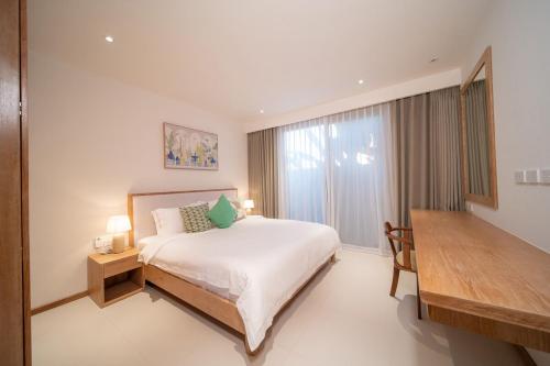 a bedroom with a bed and a large window at Modern 3BR Pool Villa T-Breeze in Laguna Phuket