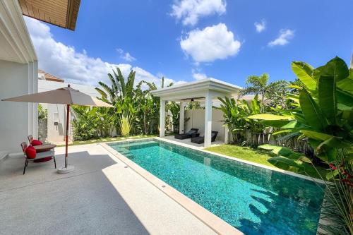 a swimming pool in the backyard of a villa at Modern 3BR Pool Villa T-Breeze in Laguna Phuket