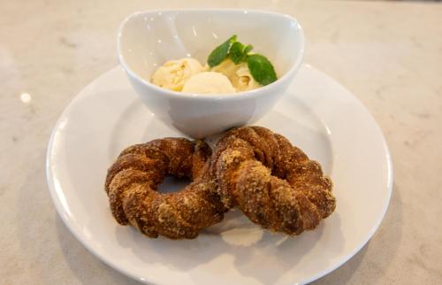 two onion rings on a plate with a bowl of food at voco Flagstaff by IHG in Flagstaff
