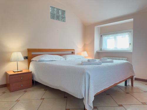 a bedroom with a large white bed and a window at Centro di Bergamo - Nel Borgo in Bergamo