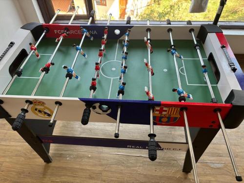 a snooker table with people playing a game on it at Bob's N Barley in Dharamshala