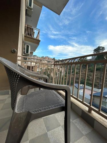 a metal bench on a balcony with a view at 2 BHK Mountain View -Family Stay With Room Service in Solan
