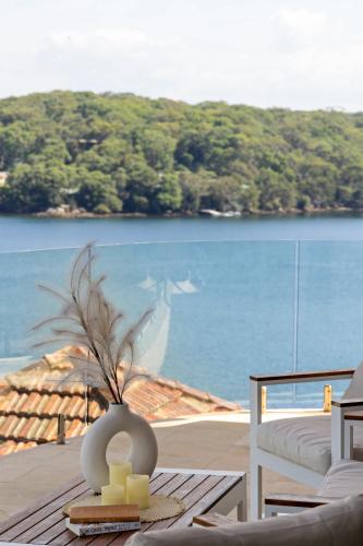 a living room with a view of the water at Waterfront Studio Room for Four - Breathtaking Coastal Escape at Caringbah South in Lilli Pilli