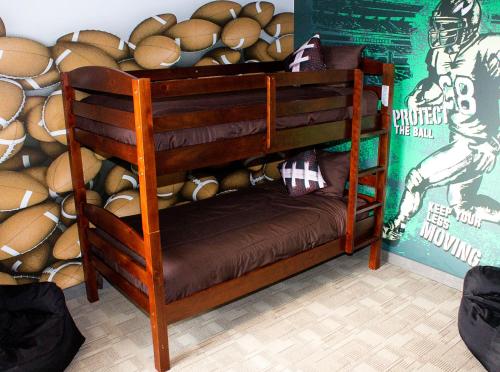 a wooden bunk bed in front of a pile of bread at Days Inn by Wyndham Regina in Regina