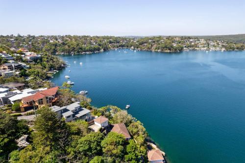 an aerial view of a lake with houses and boats at Tranquil Retreat at Caringbah South - Waterfront Ensuite King Room with Spectacular Views in Lilli Pilli