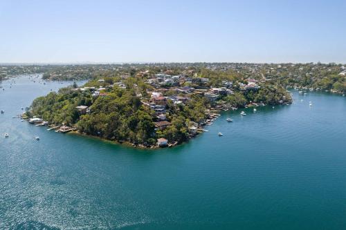 an island in a large body of water with boats at Tranquil Retreat at Caringbah South - Waterfront Ensuite King Room with Spectacular Views in Lilli Pilli