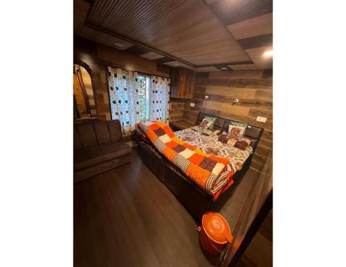 a room with a bed and a table in it at Global Hotel & Restaurant, Gulmarg in Gulmarg