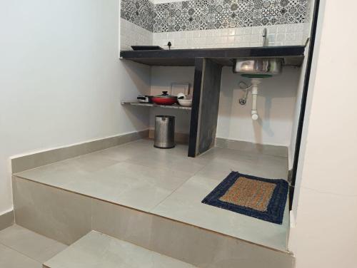 a small kitchen with a sink and a floor at Hotel de gracia baga beach in Baga