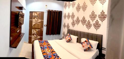 a bedroom with a bed with pillows on it at JMC Hotel RK Inn in Dakan Kotra