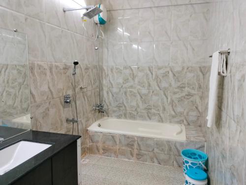a bathroom with a bath tub and a sink at SAHAY VILLA RESORT in Durbate