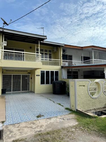 a house with a large driveway in front of it at Eco Stay Guesthouse in Kuantan